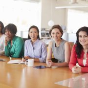 Female business colleagues in an office smiling to camera